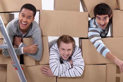 Team preparing for office removals in Battersea with labeled boxes and furniture